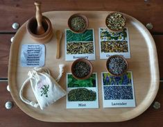 a wooden tray topped with different types of herbs