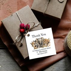 two small gift bags tied with twine on top of brown wrapping paper next to each other