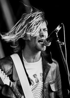 a man that is standing up with a guitar