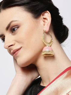 These beautiful pink & gold toned hoop jhumka earrings come with kundan stone studs & beads, are gold-plated, and are secured with a circular twist closure. These handcrafted jhumkas can be paired with any traditional outfit to add a punch of colorful boost, and help you stand out. Product color may vary based on the monitor or screen you are using.See FAQ for more details. Size Length: 7.5 cm Details Material: BrassStones: Kundan & Artificial BeadsPlating: Gold-plated Gold Chandbalis With Cutdana Detail, Brass Chandbali Hoop Earrings, Chandbali Earrings With Latkans, Chandbali Hoop Earrings With Latkans, Dual-tone Chandbali Danglers, Gold Bollywood Style Jhumkas, Bollywood Style Gold Plated Chandbalis, Festive Gold Plated Cutdana Danglers, Festive Gold Plated Danglers With Cutdana