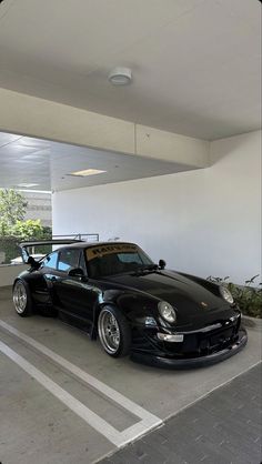 a black sports car parked in a parking garage