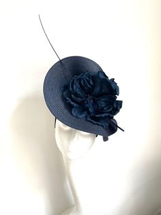 Navy blue saucer disc hat Navy blue saucer disc hat made of navy blue color polybraid base to which I attached navy blue flower and a feather. It has a navy headband with a comb attached for extra security. It will fit the average head size. You can wear this fascinator at a wedding, Christening, or Garden party  Kristine xx Blue Adjustable Fascinator For Garden Party, Navy Formal Hat With Curved Brim, Fitted Navy Hat For Kentucky Derby, Elegant Navy Hat For Evening, Navy Curved Brim Formal Hat, Blue Mini Hats With Handmade Flowers And Adjustable Fit, Adjustable Blue Mini Hats With Handmade Flowers, Blue Hats With Handmade Flowers For Royal Ascot, Navy Party Hat For Kentucky Derby