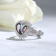 Celebrate life's biggest milestones or those everyday moments with a personalized photo ring for any occasion. Crafted in sterling silver, it features a heart shape at the center with the popular twist design on the shank which set with shimmering round cut stones. Whether you're crafting a personal keepsake or designing a one-of-a-kind gift, this beloved heart photo ring reveals the perfect surprise.Material: Plating Color: Personalized White Heart Ring For Valentine's Day, Personalized White Heart Cut Ring, Personalized White Rings For Valentine's Day, Silver Heart-shaped Engraved Promise Ring, Silver Heart Ring For Wedding On Mother's Day, Personalized White Heart Ring For Wedding, Personalized Silver Heart Ring For Valentine's Day, Customizable Silver Ring For Valentine's Day, Personalized White Heart Ring As A Gift