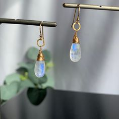 "Moonstone Earrings, Teardrop Earrings, June Birthstone, Earrings for Women, Gemstone Earrings, Gift for Girlfriend, Dangle Earrings, Gift for Her Sometimes less is more. Our polished Teardrop Moonstone earrings need no introduction. They are our \"clear\" favorite, no pun intended! Refreshingly light for wearing every day yet bold enough to take center stage for special occasions. When you want to dress up your outfit with the perfect balance of understated glamour, this earring is for you. The Moonstone Crystal Dangle Earrings, Moonstone Dangle Earrings With Ear Wire, Moonstone Drop Earrings With Ear Wire, Gold Moonstone Drop Crystal Earrings, Everyday Moonstone Gemstone Earrings, Minimalist Hypoallergenic Moonstone Earrings, Moonstone Drop Earrings For Gift, Dainty Moonstone Earrings For Everyday, Elegant Moonstone Dangle Crystal Earrings