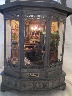 an elaborate display case with figurines in the shape of a desk and chair