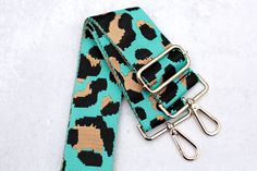 Adjustable teal leopard print purse strap. Pair this with your favorite crossbody messenger bag, purse, tote bag or handbag.  This strap is also the perfect addition for game day or to show off your school spirit. Adjustable length 31 - 54 inches (including clasps) 2 inches wide Gold hardware Design is shown on both sides of the strap (the back is the reversible version of the front) Strap For Bag, Leopard Print Bag, Printed Purse, Shoulder Strap Bag, Strap Bag, Purse Strap, Crossbody Messenger Bag, Guitar Strap, School Spirit