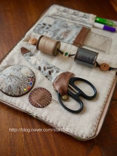 a pair of scissors and some other items on a table