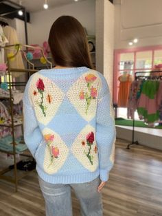 Add a touch of whimsy to your wardrobe with our Fleur Diamond and Flower Knit Cardigan! This sky blue sweater features delicate diamond stitching and colorful flowers, making it the perfect playful addition to any outfit. The bright colors are perfect for layering on any outfit for Spring. Stay cozy and stylish at the same time with this charming cardigan. Light Blue Spring Cardigan, Light Blue Cardigan For Spring, Cute Blue Spring Sweater, Blue Crew Neck Trendy Cardigan, Trendy Blue Crew Neck Cardigan, Cute Blue Knit Cardigan, Light Blue Knit Cardigan For Spring, Light Blue Crew Neck Sweater For Spring, Trendy Blue Spring Cardigan