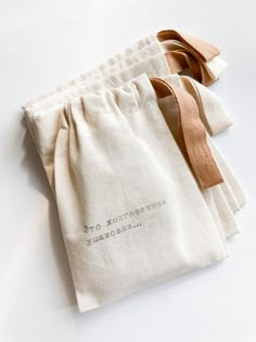 three bags with ties tied to them sitting on a white counter top next to each other