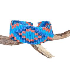 Lovely handmade Huichol beaded bracelet, southwest style,  tribal symbol pattern, light blue, lavender, orange and glitter blue colour, from our Fair Trade partners in Mexico.  Size is approx. between 18.5long cm by 2.5 cm wide. Please also visit my new shop, BALI COCONUT BY ROSA made in Fairtrade partnership with fine Balinese artisans and featuring all natural jewellery: https://www.etsy.com/uk/shop/BaliCoconutbyRosa Spend over $35 US Dollars with us and receive FREE postage for orders to the Artisan Blue Beaded Bracelets For Beach, Artisan Blue Beaded Bracelets, Artisan Blue Bracelets For The Beach, Blue Artisan Adjustable Beaded Bracelet, Adjustable Artisan Blue Beaded Bracelets, Adjustable Blue Artisan Beaded Bracelets, Blue Bohemian Beaded Bracelets With Large Beads, Artisan Blue Beaded Bracelets With Round Beads, Adjustable Blue Beaded Bracelets In Hippie Style