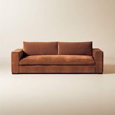 a brown couch sitting on top of a white floor