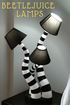 two lamps with black and white stripes on them, one is turned into a lamp