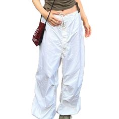 White Low-rise Drawstring Pants with Pockets White Bottoms With Drawstring And Loosely Fitted Hips, White Drawstring Bottoms Loosely Fitted Hips, White Summer Cargo Pants With Drawstring, White Drawstring Cargo Pants For Summer, Baggy Drawstring Parachute Pants For Summer, Casual Drawstring Pants For Spring, Summer Cotton Parachute Pants With Drawstring, Summer Parachute Pants With Drawstring, White Stretch Parachute Pants For Summer