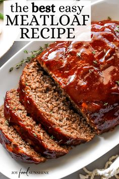 sliced meatloaf on a white plate with text overlay that reads the best easy meatloaf recipe