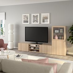 a living room scene with focus on the entertainment center and large screen tv in the corner