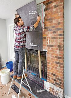 a man standing on top of a ladder next to a fire place