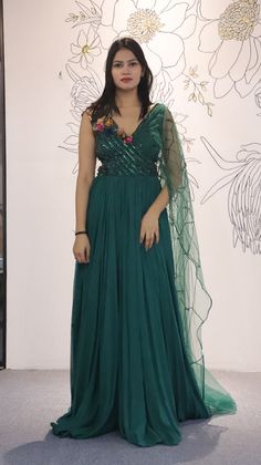 A mix of royal and modern, this long dress in Sea Green colour handcrafted on georgette with multicolour crystal and stripes has an entirely different look because of the jacket. Style this for the classic indo western look.Fabric- georgette with net, work- metal stripes with multicolor crystalOccasion: Wedding ,Cocktail, Family & Pooja,Reception ,EngagementNo. Of Components: 1 Style: Gown Fabric: Georgette Work: Sequin, Cut dana Colour: Sea Green Chest: 36 Note:- Originally Stitched in 36 but c Hand Embellished Semi-stitched Maxi Dress, Hand Embellished Semi-stitched Party Dress, Designer Party Wear Dresses With Cape Sleeves, Designer Cape Sleeve Party Dresses, Designer Party Dress With Cape Sleeves, Festive Embellished Maxi Dress For Designer Wear, Designer Georgette Gown Hand Embellished, Festive Georgette Dresses With Cape Sleeves, Designer Hand Embellished Georgette Gown