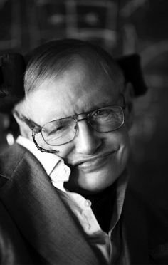 a black and white photo of a smiling man