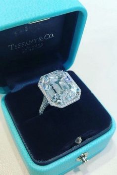 an engagement ring in a blue velvet box