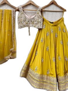 Gold Palazzo Set With Dori Work For Party, Gold Dola Silk Palazzo Set With Mirror Work, Gold Lehenga With Mirror Work In Georgette, Yellow Mirror Work Sets In Dola Silk, Gold Georgette Set With Mirror Work, Yellow Dola Silk Set With Mirror Work, Gold Palazzo Set With Mirror Work For Navratri, Gold Georgette Palazzo Set With Mirror Work, Yellow Sets With Mirror Work In Traditional Drape