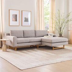 a living room with a sectional couch and coffee table on the rug in front of it