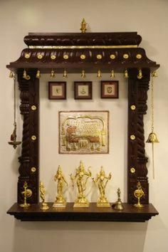 an ornate wooden shelf with statues on it