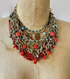 "This is an instant collection of necklaces with a bohemian style in red and turquoise.  Wear them together or on their own to create different looks. The necklaces are a combination of glass, metals, materials, textures and finishes for an amazing assortment!  (1)  Fabulous gold tone metal, chain bib necklace. The metal links have a textured finish.  Slices of red coral and dyed turquoise howlite beads dangle and move.  Great condition.  19\" - 22\" long inside neckline measurement. (2) Vintage multi strand deep red glass seed bead necklace.  14 strand end with silver toned round bead and a J clasp.  Great condition.  21\" long (3) Woven strand of robins egg blue seed beads. Closes with a button.  20\" long (4) Multi beaded strand with darkened metal in red and turquoise blue glass.  Roun Vintage Red Necklace With Dangling Beads, Red Vintage Necklace With Dangling Beads, Red Beaded Bohemian Bib Necklaces, Bohemian Turquoise Bib Necklace With Colorful Beads, Adjustable Red Bohemian Jewelry, Bohemian Adjustable Red Jewelry, Adjustable Bohemian Red Jewelry, Artisan Multi-strand Red Necklaces, Red Large Beads Festival Jewelry