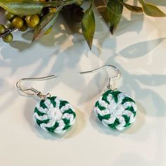 the green and white earrings are on display