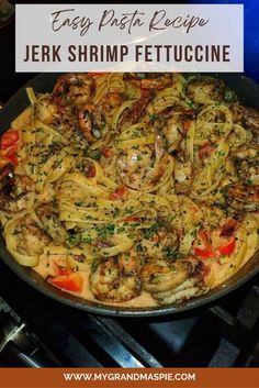 a skillet filled with shrimp and pasta