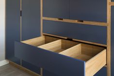 a blue cabinet with drawers in it