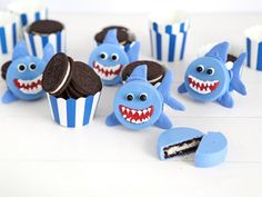 blue and white cupcakes with shark decorations on them