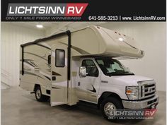 a white truck with a camper attached to it's side in a garage