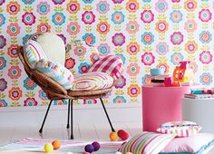 a chair and ottoman in front of a colorful wallpaper