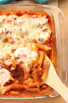 a casserole dish filled with pasta and meat covered in sauce, cheese and parmesan