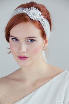 a woman with red hair wearing a white dress and a headband on her head