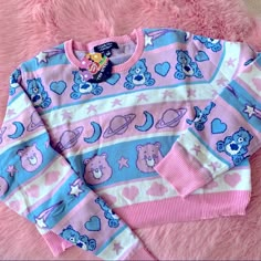 Brand New Care Bears X Dolls Kill Crop Sweater. Blue, White, And Pink Bears, Stars, Hearts, Clouds, Moons, And Planets All Over This Little Cutie! Pink Trim. Care Bear Sweater, Care Bear Clothes, Pink Kawaii Long Sleeve Sweater, Pink Long Sleeve Kawaii Sweater, Pink Kawaii Sweater For Spring, Playful Pink Crew Neck Sweater, Pink Long Sleeve Kawaii Top, Blue Kawaii Winter Tops, Kawaii Blue Winter Tops