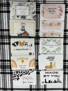 several different types of stickers are displayed on a plaid tablecloth with black and white checks