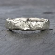 Forged from the essence of fire, our Mineral rings emerge as our fresh line of free-form wedding bands. Evoking nature's artistry, it appears as though these rings were sculpted from molten lava. This 5mm band, suitable for men or as a broader choice for women, is an unparalleled selection for the groom yearning for a piece absent from conventional stores. Each ring is handcrafted by Lilia and available in sizes G to W, with others sizes available on request. Committed to sustainability, the 950 Nature Inspired Wedding Bands, Ring Chart, Birthstone Stacking Rings, How To Wear Rings, Plus Size Rings, Nature Inspired Wedding, Molten Lava, Silver Wedding Ring, Paper Ring