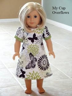 a doll is standing on the floor in a room with tile floors and white tiles