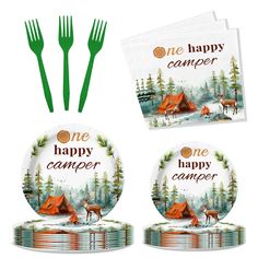 a set of four dinner plates and forks with the words one happy camper printed on them