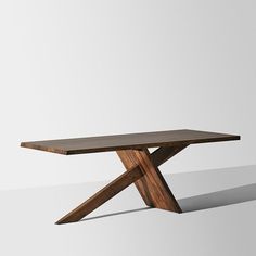 a wooden table sitting on top of a white floor