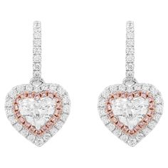 Beautiful Heart shaped Dangling earrings with certified White diamonds and Rare Pink diamonds. Heart Shape White Diamond (GIA Certified) - 0.50 cts Heart Shape White Diamond (GIA Certified) - 0.50 cts Pink diamond - 0.14 cts Round Brilliant cut white diamonds - 0.53 cts 18k Gold HYT Jewelry is a privately owned company headquartered in Hong Kong, with branches in Tokyo, New York, and Bangkok. The company specializes in fine jewelry. It is renowned for an exceptional range of Fancy Color Diamonds and Color Stones (including Colombian Emeralds and Burma Ruby) ranging from rare to the rarest in various hues and color intensities studded in the jewelry with the finest craftsmanship. HYT is committed to producing the finest and exquisite jewelry pieces with sophisticated state-of-the-art techno Pink Diamond Earrings, Gold Diamond Drop Earrings, Argyle Pink Diamonds, Pink Diamonds, Diamond Drop Earrings, Diamond Drops, Fancy Color Diamonds, Timeless Jewelry, Lovely Earrings