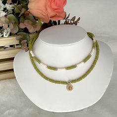 Heishi necklace, olive green necklace, Heishi boho necklace, dainty flower necklace, simple beaded necklace, summer bead necklace. These boho chic chokers are very trendy and they match with your daily outfit. If you are looking for stylish summer necklace to enhance your daily outfit, you found them! They're easy to wear everyday alone or layered with other favorite necklaces. 💕 ITEM DETAILS: Length: 14 - 16 inches. The length of the necklace refers to the total length from end-to-end. Materia Bohemian Flower Necklace With Round Beads For Beach, Bohemian Beach Flower Necklace With Round Beads, Bohemian Necklace With Flower Charm And Round Beads, Dainty Green Jewelry For Beach, Adjustable Green Flower Necklace With Round Beads, Bohemian Beaded Necklace With Flower Charm For Summer, Green Bohemian Flower Charm Necklace, Green Bohemian Necklace With Tiny Beads, Adjustable Green Flower Beaded Necklaces