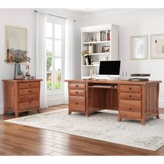 a wooden desk sitting on top of a hard wood floor next to a book shelf