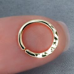 a gold plated ring on someone's finger