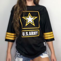 a young woman is posing for a photo wearing an army t - shirt with the word u s army on it