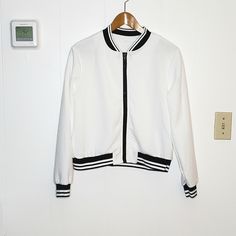 Nwot White & Black Textured Baseball Jacket Size L. Smoke Free Home. Zippered Closure 21' Length 22' Pit To Pit 23' Sleeves Ub White Spring Track Jacket With Zipper, White Track Jacket With Zipper For Spring, White Track Jacket For Spring, White Track Jacket With Zipper Closure For Fall, Trendy White Outerwear With Ribbed Cuffs, White Zipper Closure Outerwear For Work, White Sporty Outerwear For Work, Sporty White Outerwear For Work, Varsity Jackets