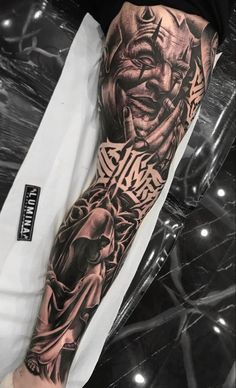 a man's arm with a tattoo on it that has an image of a demon