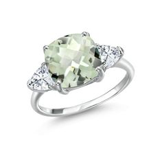 an oval cut green amethorate and diamond ring with three stones on each side