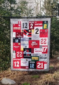 a quilt hanging on a clothes line with numbers and other items all over the place